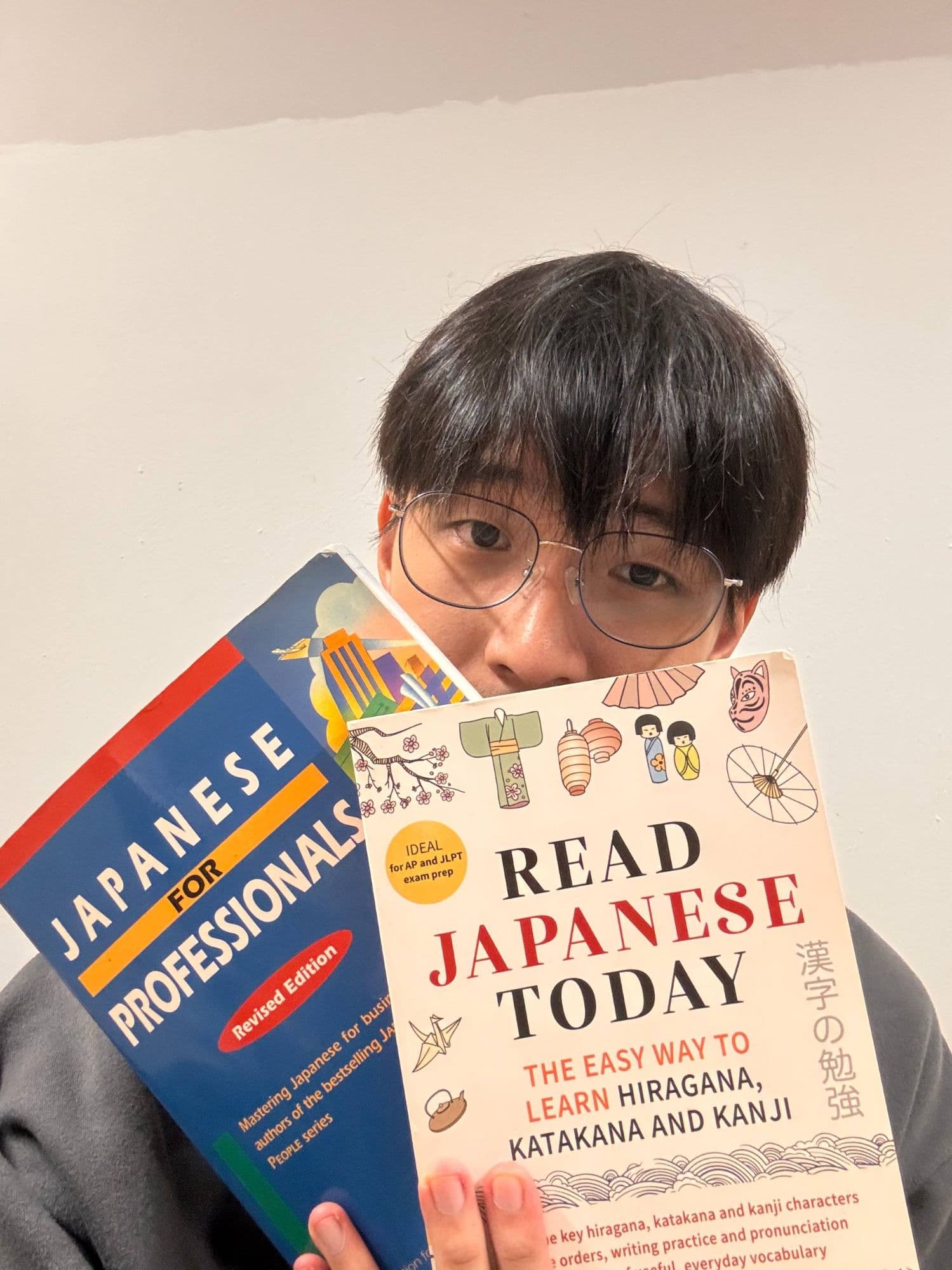 The founder holding two Japanese textbooks